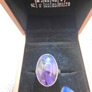 sterling silver amethyst ring featuring a large, oval-shaped purple stone.